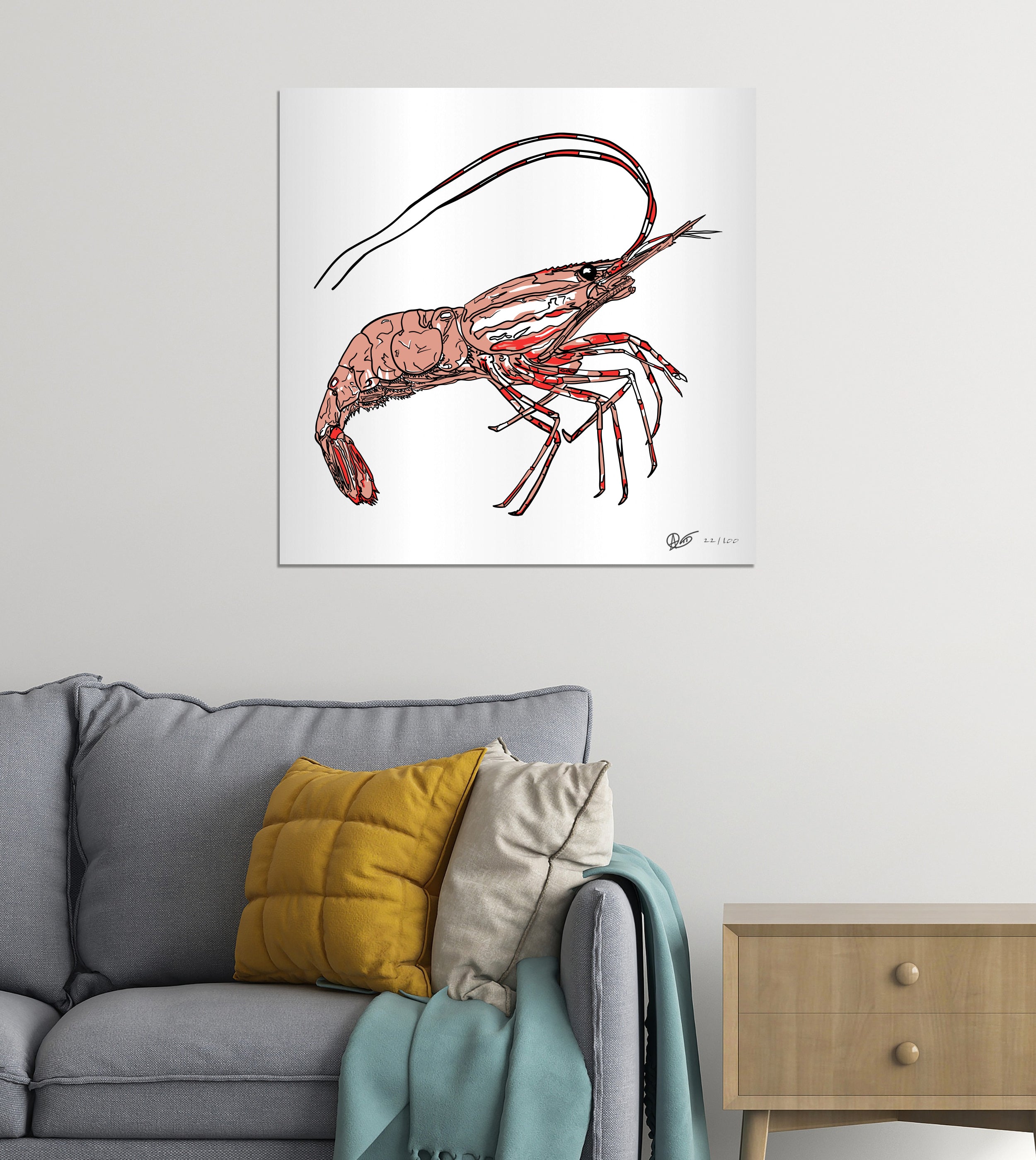 Poster of a detailed spotted prawn illustration on a wall above a gray sofa with colorful cushions.