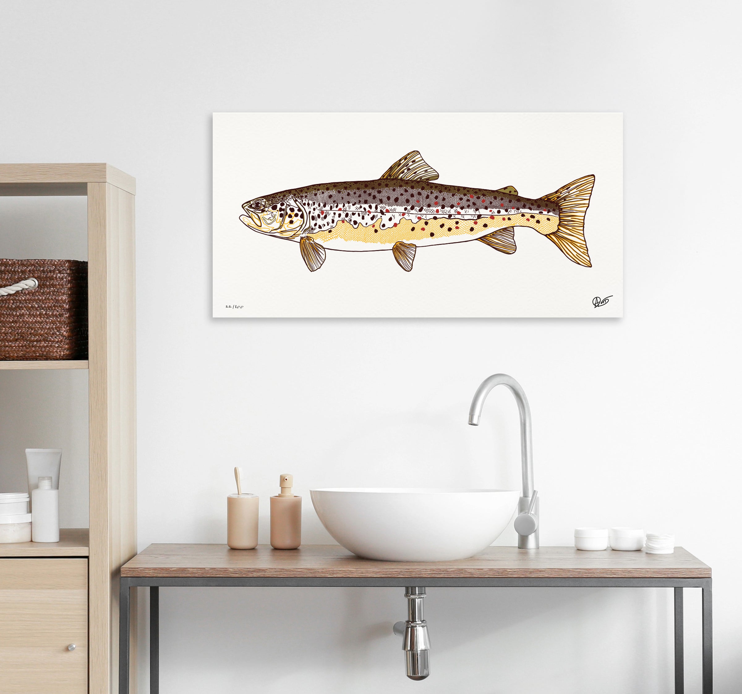 Rainbow trout canvas printon a wall above a bathroom sink with wooden cabinets.