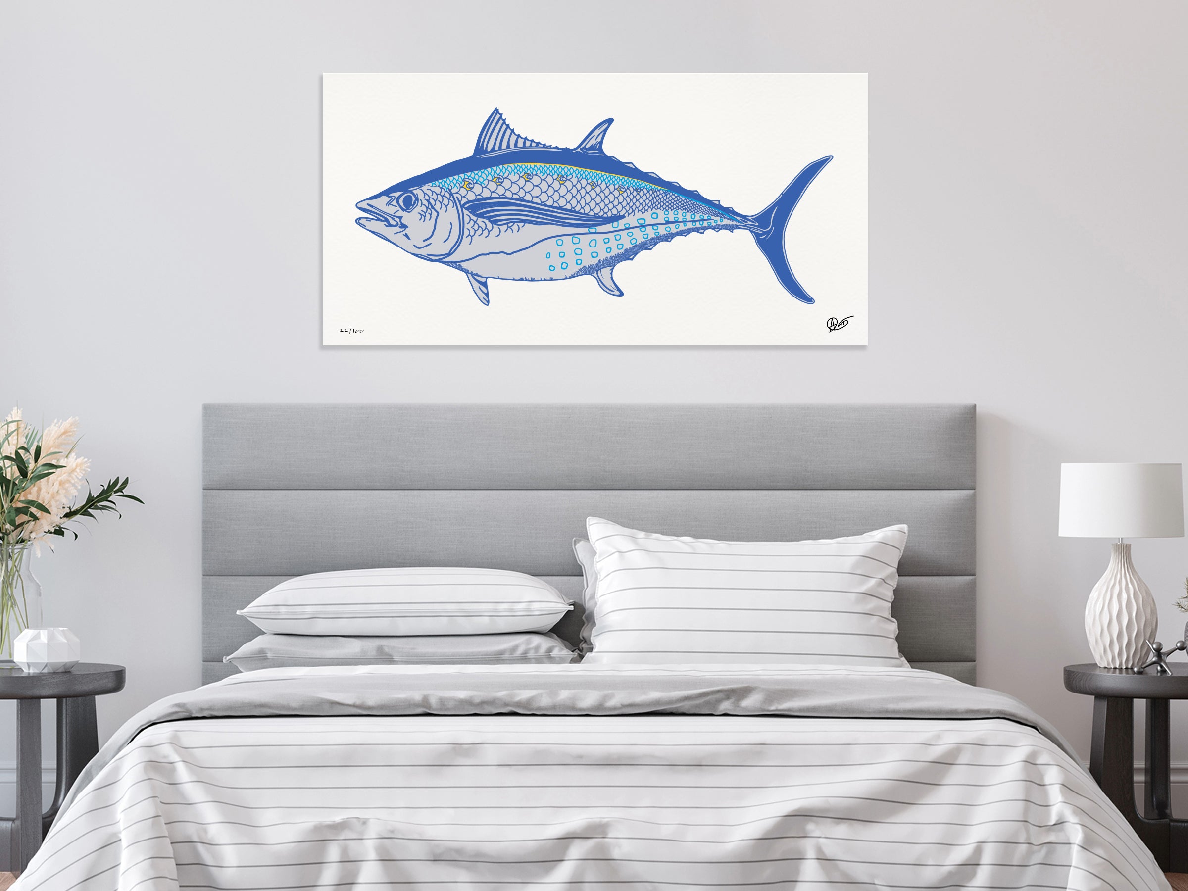 Bedroom with a gray headboard and an albacore print on the wall.