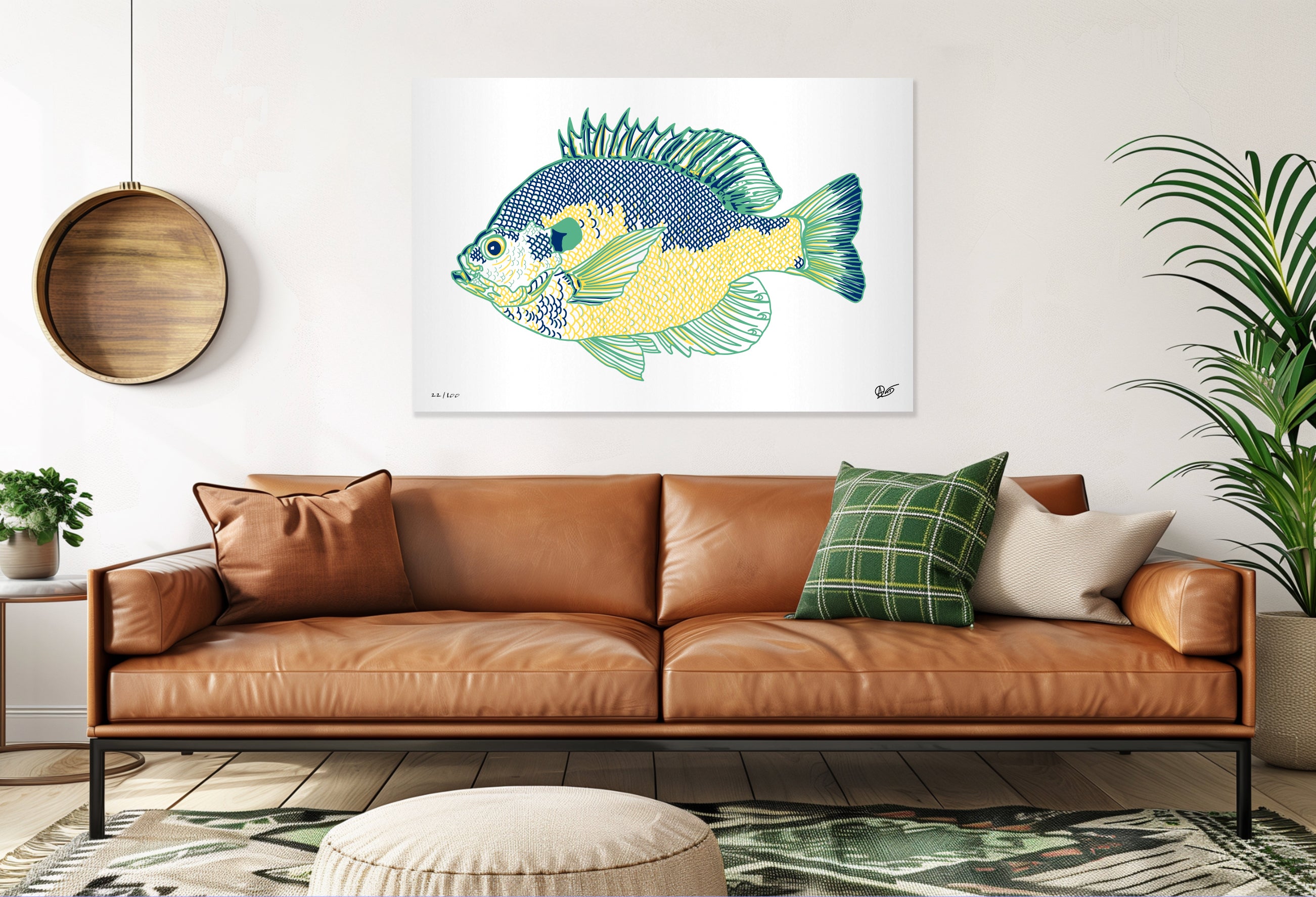 Living room with a brown leather sofa, decorative pillows, and a Bluegill fish print on the wall.
