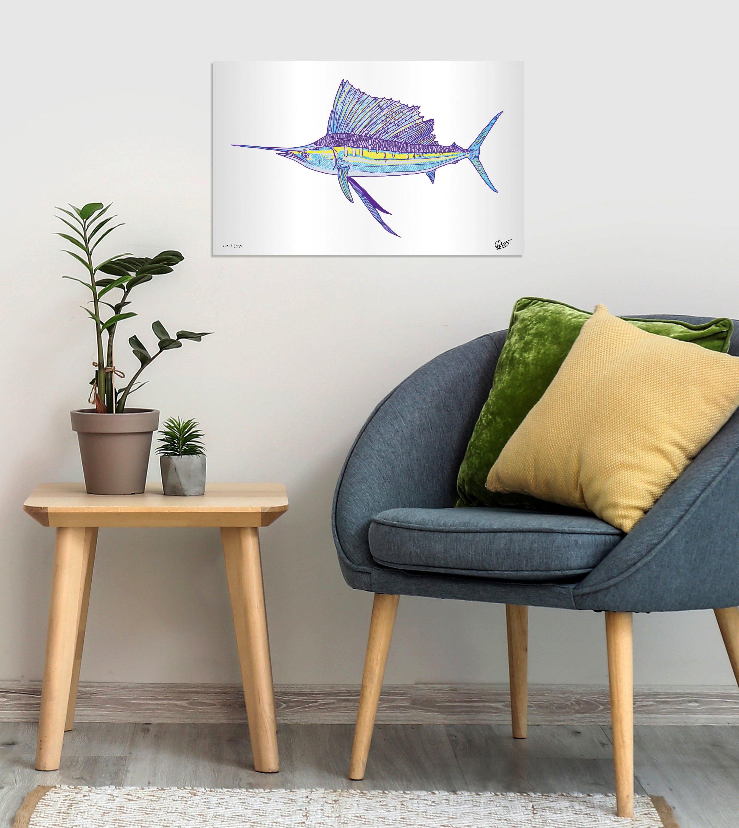 Modern interior with a blue chair, side table, and decorative sailfish metal print on the wall.