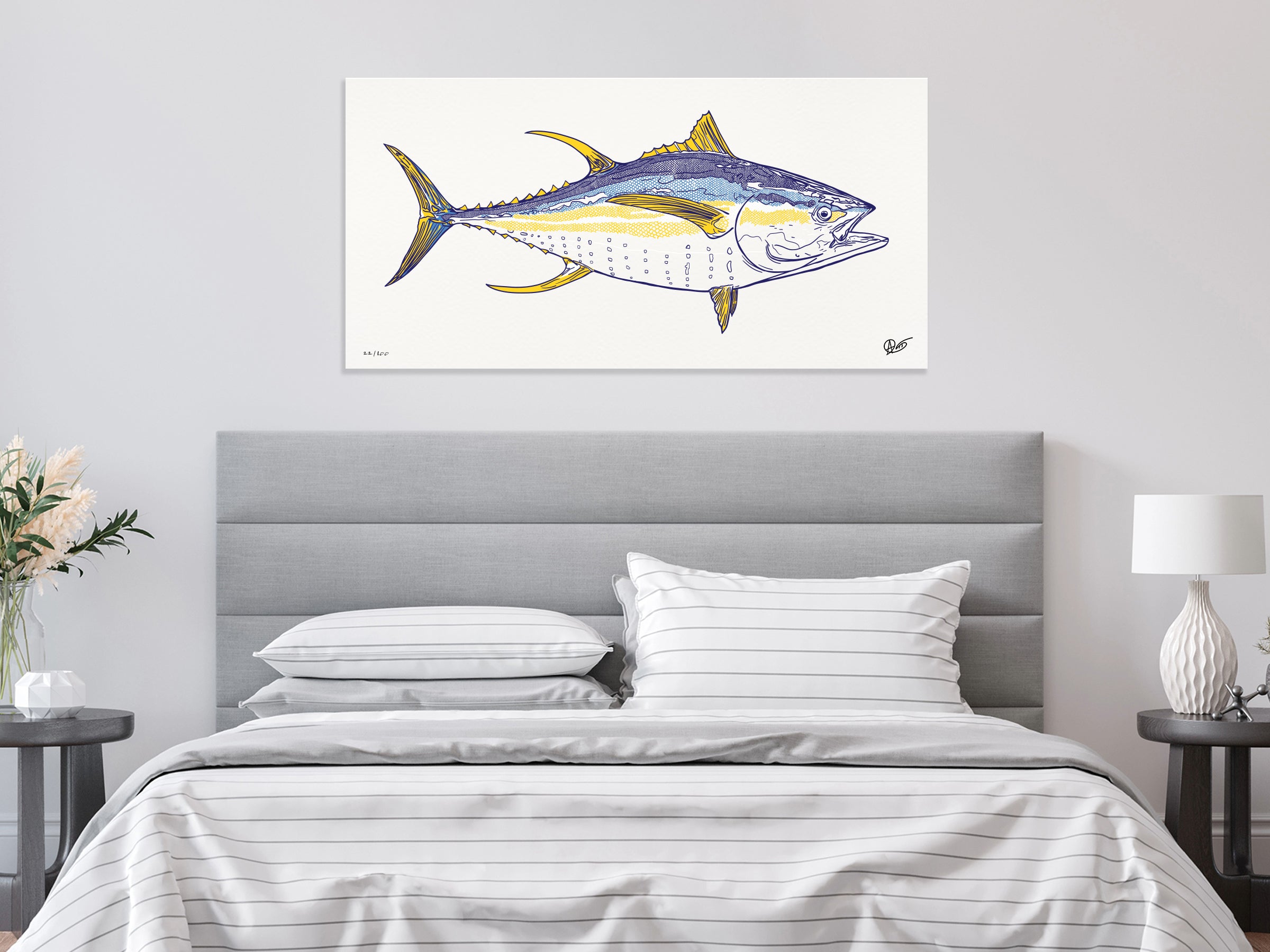 Bedroom with a large yellowfin print on the wall above the bed.