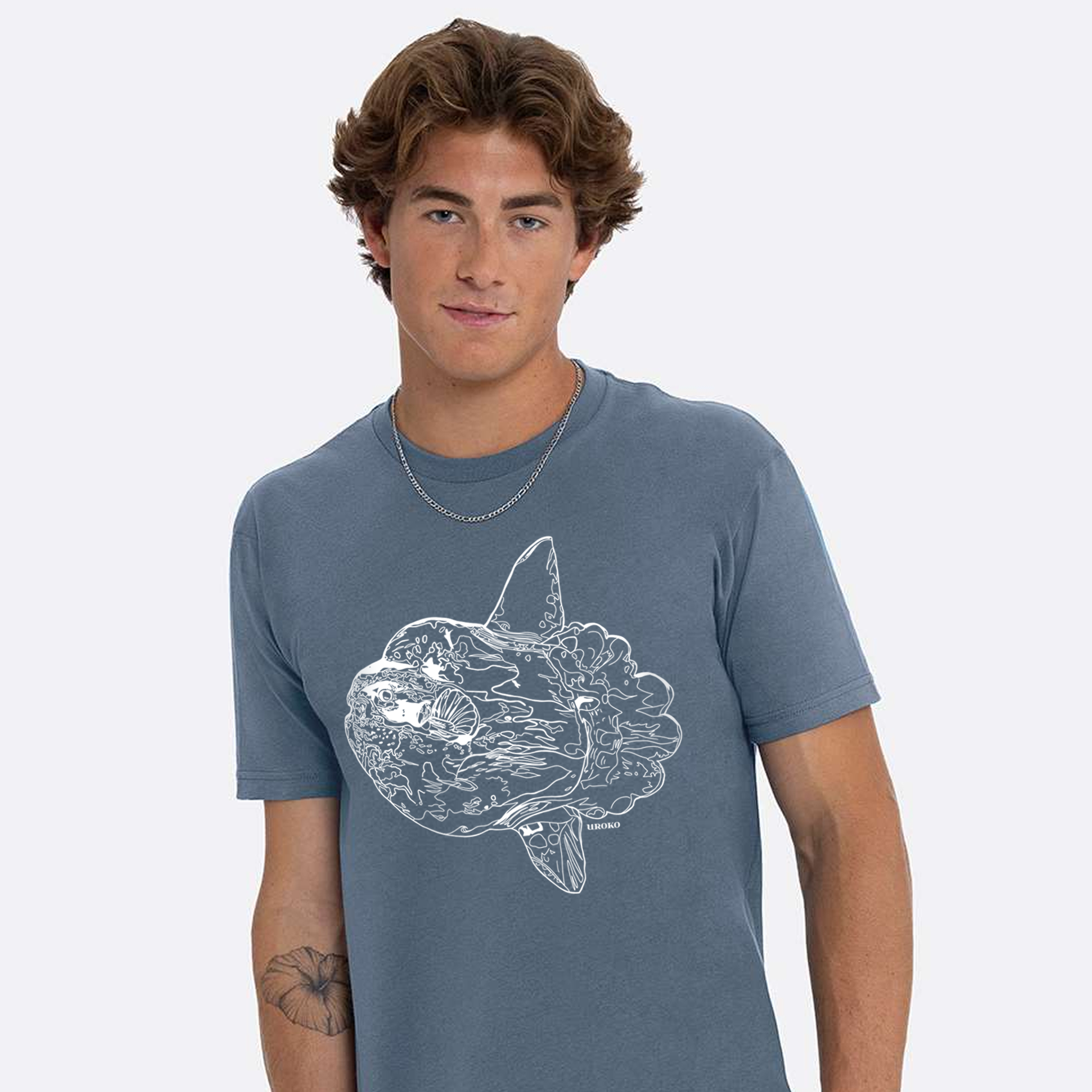 Person wearing a blue t-shirt with a Mola Mola graphic design on a white background