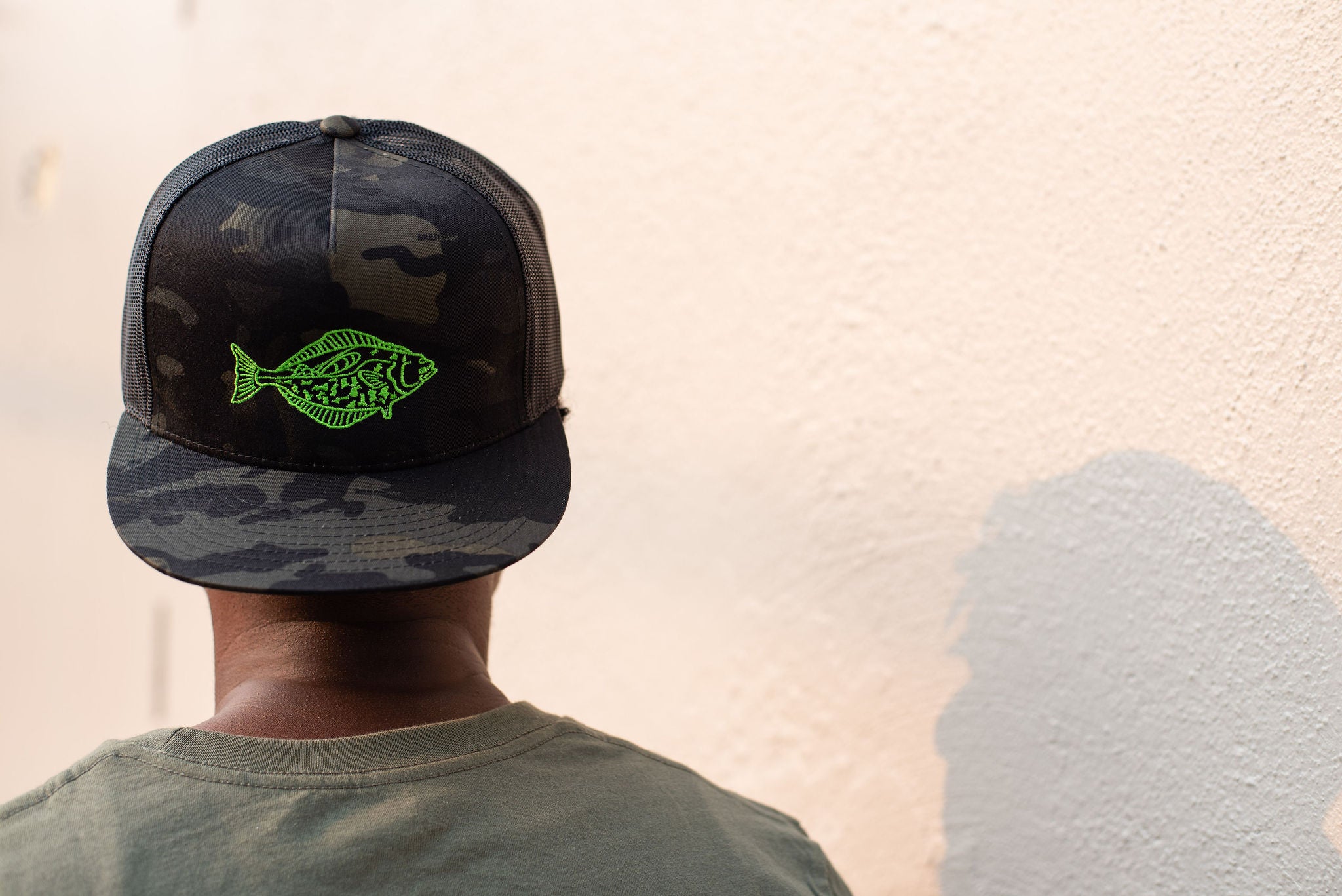 Camo trucker hat backwards on model