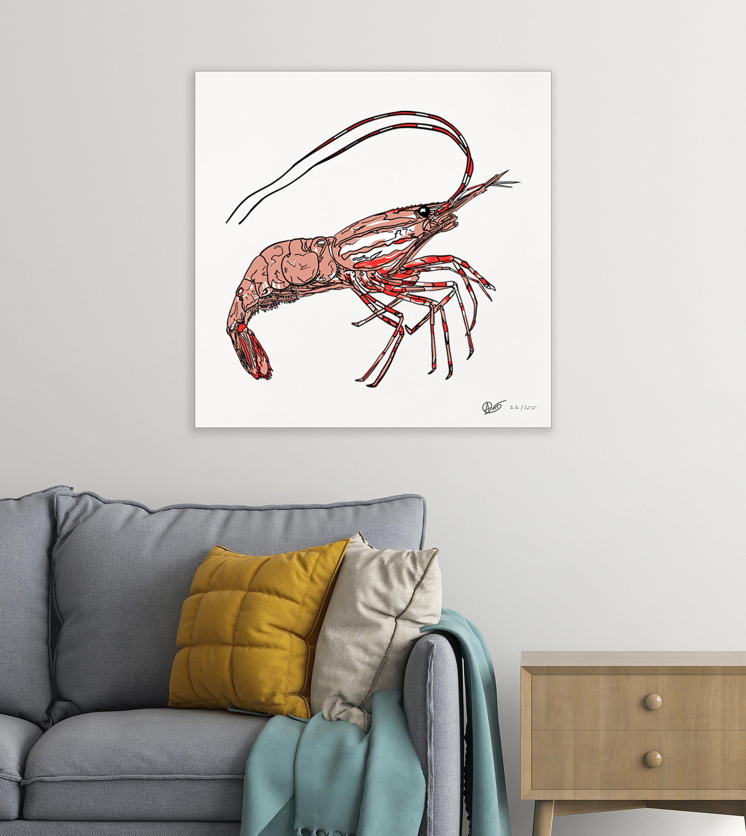 Framed artwork of a spotted prawn on a wall above a sofa with colorful cushions.