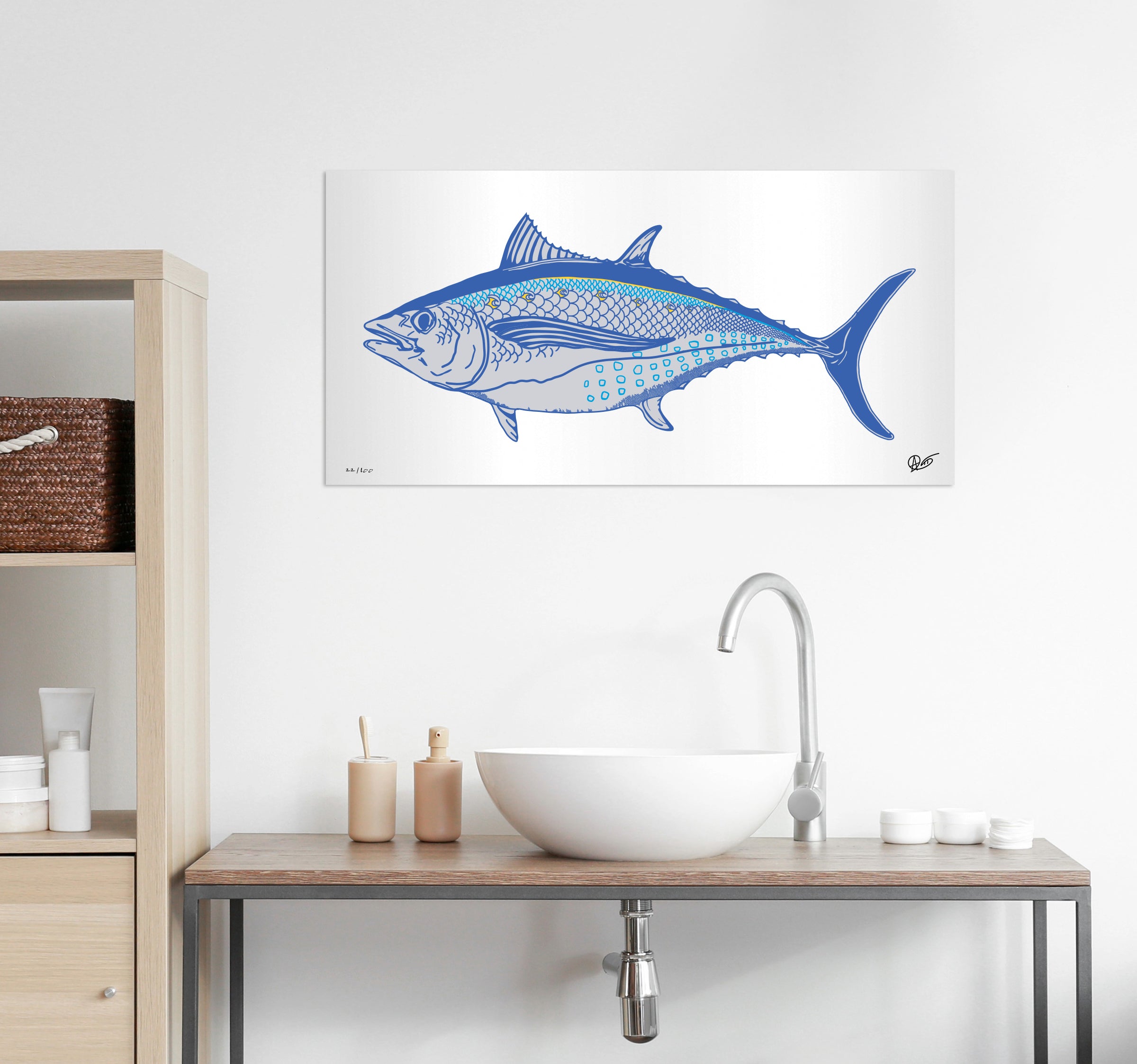 Albacore metal print on a white wall above a bathroom sink.