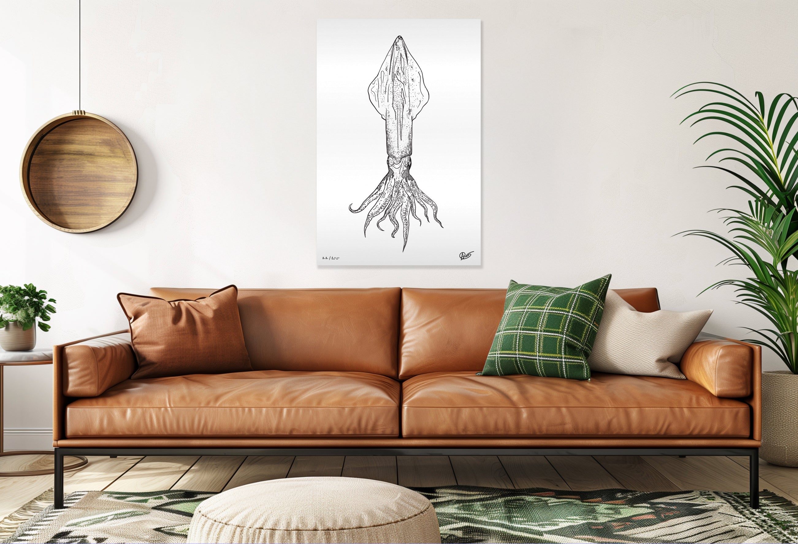 Brown leather sofa in a living room with a plant and squid art.