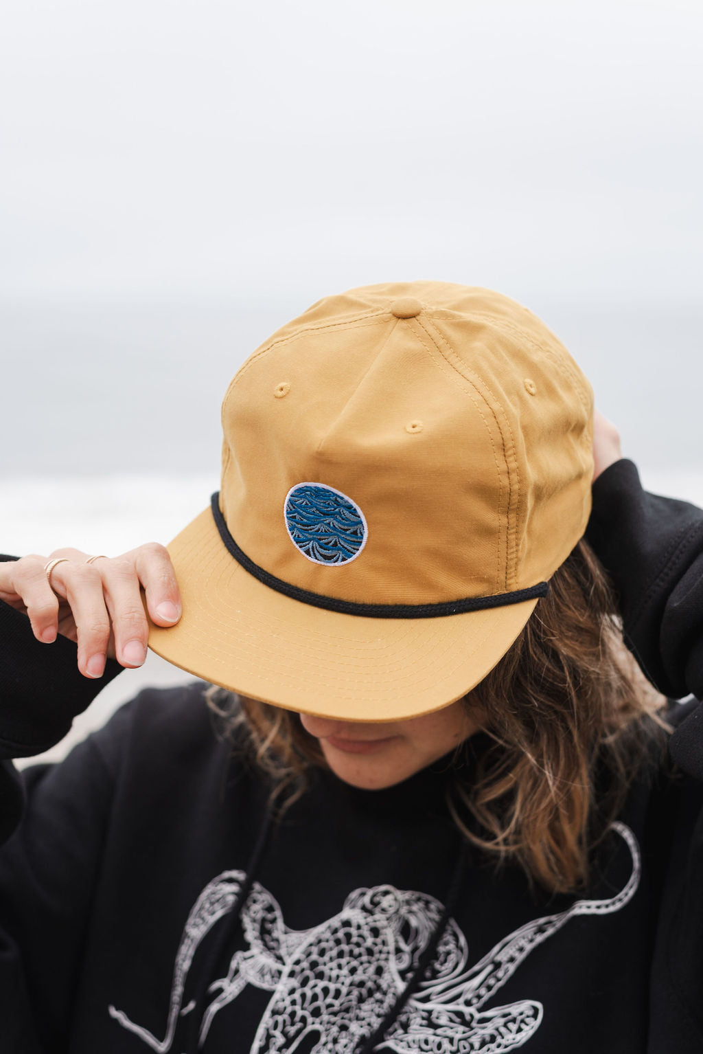 Unstructured biscuit grandpa hat with storm artwork worn outdoors