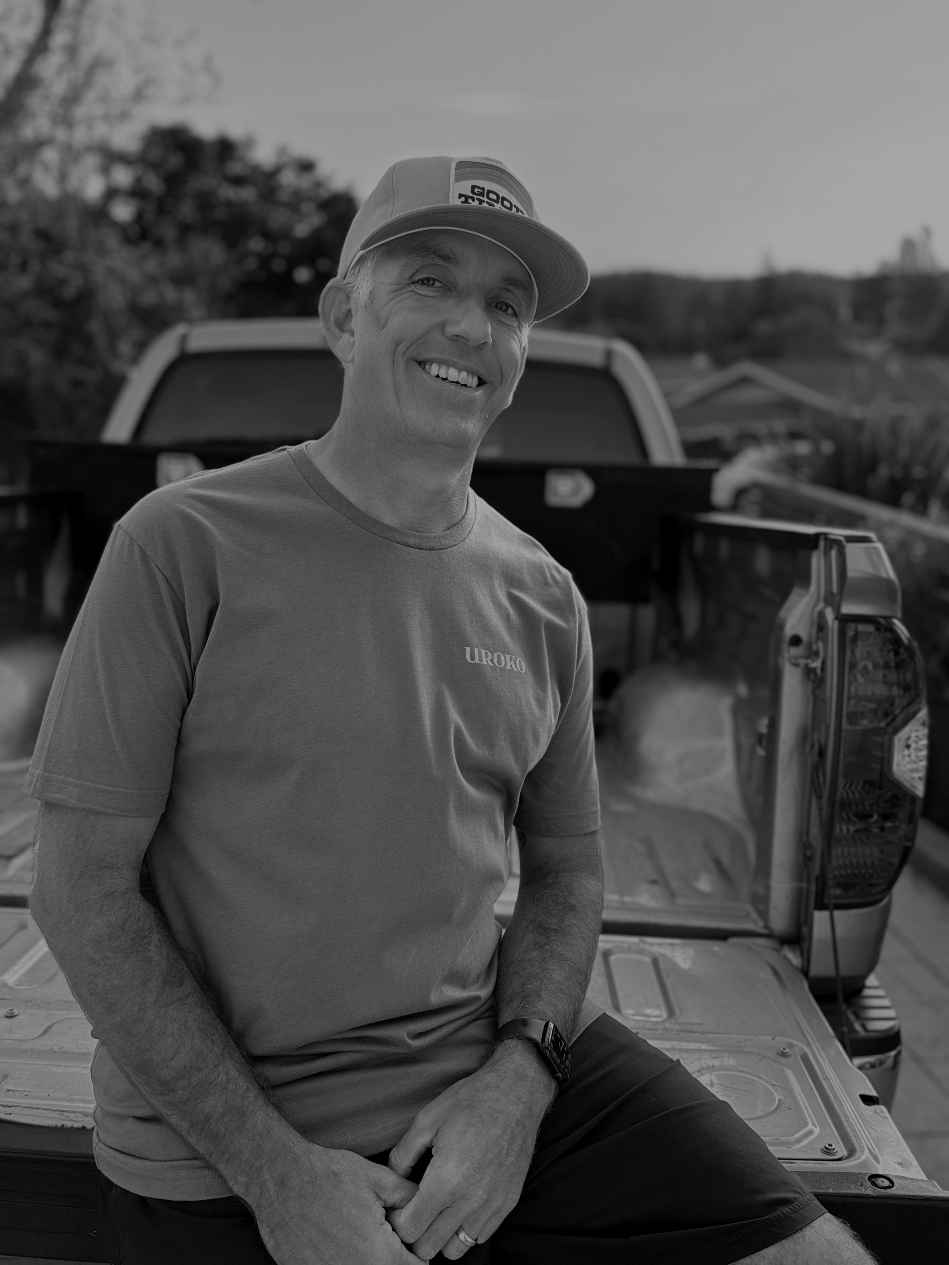 Artist Alex Czech sitting on a truck bed 
